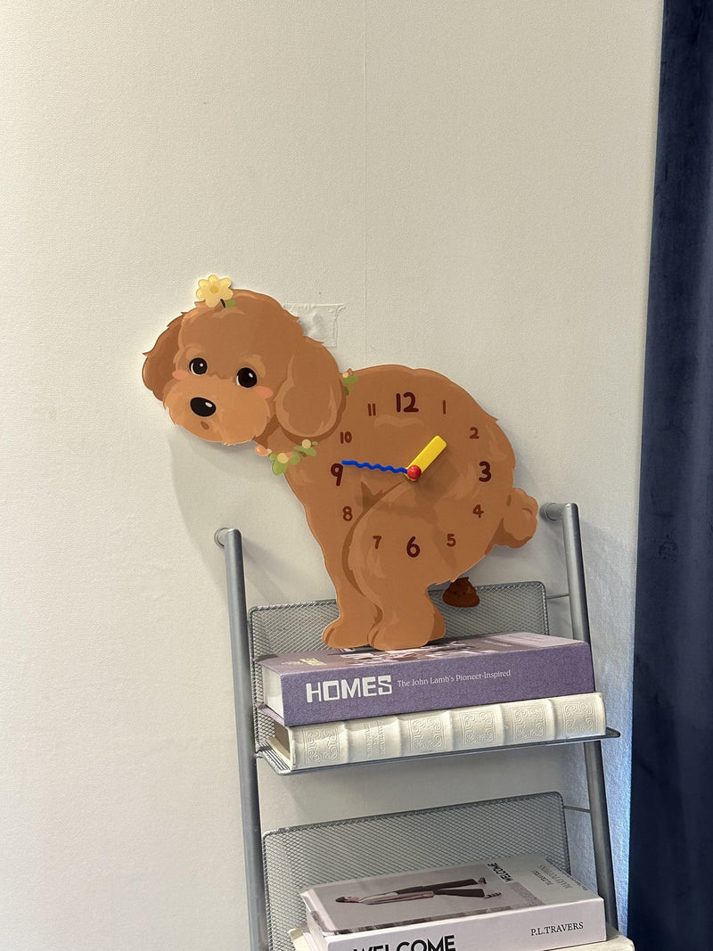 Brown Teddy Poodle pendulum wall clock above a bookshelf